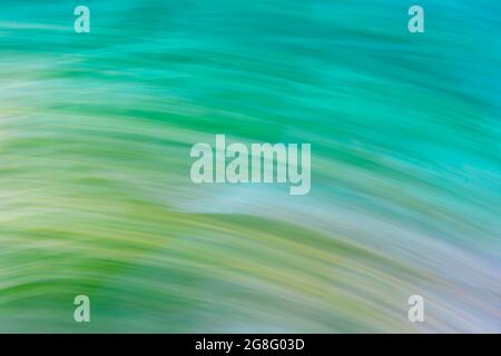 Abstract gradient multicolor background of turquoise-green-yellow circular lines. Photo effect. Stock Photo