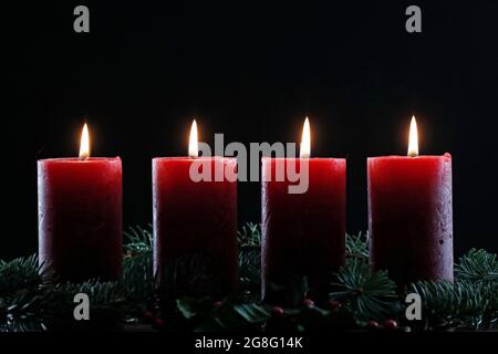 Natural Advent wreath or crown with four burning red candles, Christmas composition, France, Europe Stock Photo