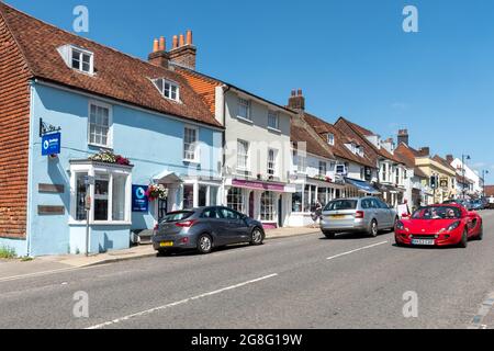 Colourful terraced houses and businesses in Alresford, a small Hampshire town, England, UK. View along West Street. Stock Photo