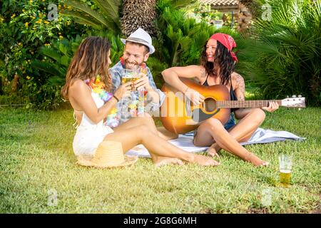 happy young friends toast with beer at a party Stock Photo