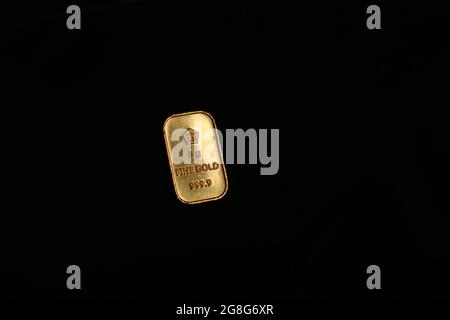 Fine gold bar (goldbar) on black background, produced by PT Aneka Tambang (Antam) Indonesia. Stock Photo