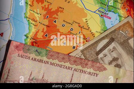 Top view of money, banknote of Saudi Arabian Riyal and the Saudi Arabia map for background. Business, Finance, Economy and Investment concept Stock Photo