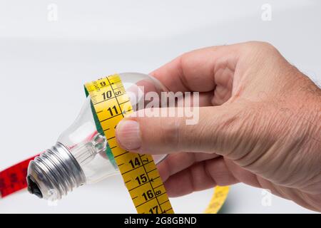 Tailor's and dressmaker's tape measure, flexible, yellow, for measuring parts of the human body to create suits and dresses. Stock Photo