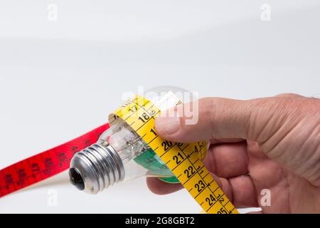 Tailor's and dressmaker's tape measure, flexible, yellow, for measuring parts of the human body to create suits and dresses. Stock Photo