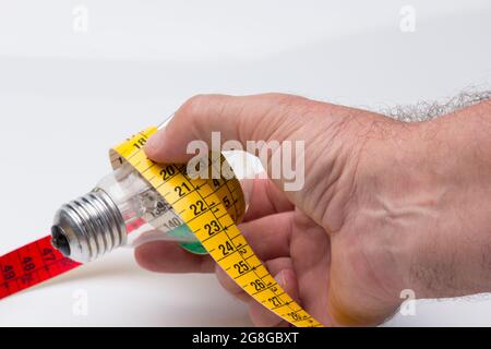 Tailor's and dressmaker's tape measure, flexible, yellow, for measuring parts of the human body to create suits and dresses. Stock Photo