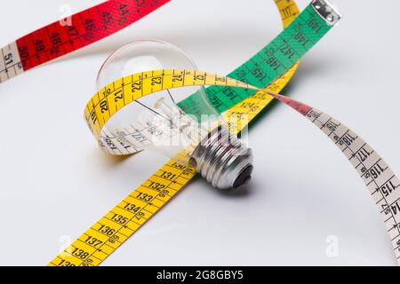 Tailor's and dressmaker's tape measure, flexible, yellow, for measuring parts of the human body to create suits and dresses. Stock Photo