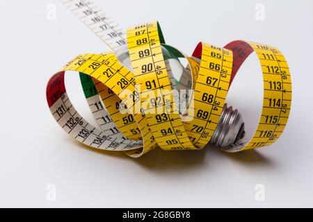 Tailor's and dressmaker's tape measure, flexible, yellow, for measuring parts of the human body to create suits and dresses. Stock Photo