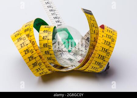 Tailor's and dressmaker's tape measure, flexible, yellow, for measuring parts of the human body to create suits and dresses. Stock Photo