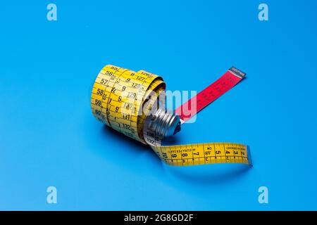 Tailor's and dressmaker's tape measure, flexible, yellow, for measuring parts of the human body to create suits and dresses. Stock Photo