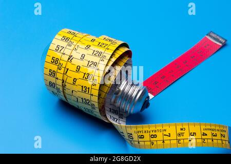 Tailor's and dressmaker's tape measure, flexible, yellow, for measuring parts of the human body to create suits and dresses. Stock Photo