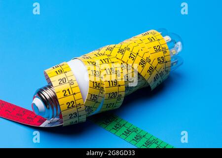 Tailor's and dressmaker's tape measure, flexible, yellow, for measuring parts of the human body to create suits and dresses. Stock Photo