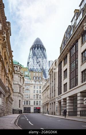 The Gherkin building seen from an empty street in the City of London Stock Photo