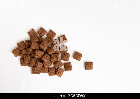 heap of chocolate pads isolated on white background, chocolate corn pads, healthy breakfast, top view Stock Photo