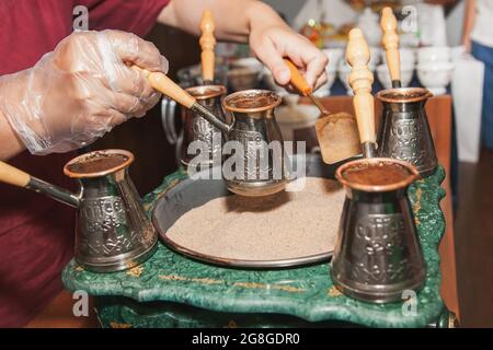 https://l450v.alamy.com/450v/2g8gdr0/woman-makes-turkish-coffee-on-a-coffee-machine-with-sand-in-cezve-oriental-east-coffee-2g8gdr0.jpg