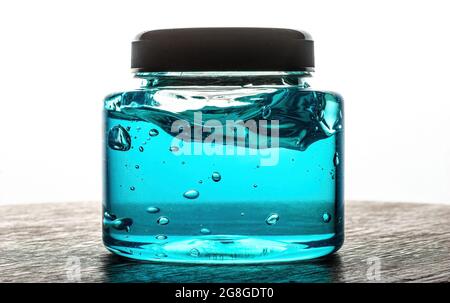 Transparent blue gel with bubbles in a tube. Blank cosmetic lotion bottle cream on white background Stock Photo