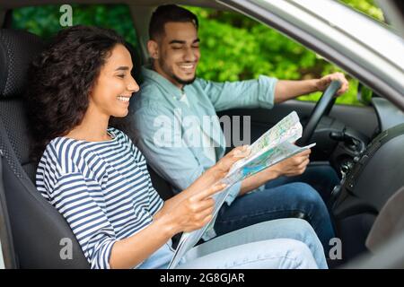 Young loving arab man and woman having car trip together Stock Photo