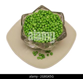 green peas separated from the shell, pea seeds, lies in glassware and on a square plate, on a white background in isolation Stock Photo