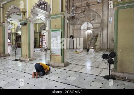 KOLKATA, WEST BENGAL, INDIA - MAY 27 2019 : Young Muslim devotee praying at Nakhoda Masjid, one of the oldest Masjids of Kolkata. Public place of hist Stock Photo