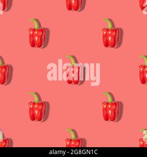 Red pepper seamless pattern on a red background. Vegetable pattern for the print. Abstract food background. Top view, flat lay.