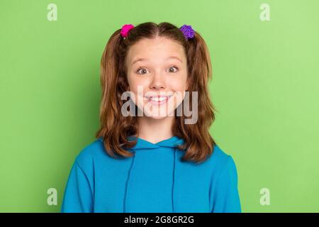 Photo of amazed happy cheerful young little girl smile good mood positive face isolated on green color background Stock Photo