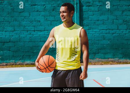 young latin man playing basketball portrait in Mexico Stock Photo