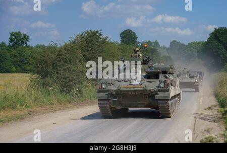 A British army Warrior FV512 Mechanised Recovery Vehicle tank on exercise kicking up clouds of dust on Salisbury Plain Stock Photo
