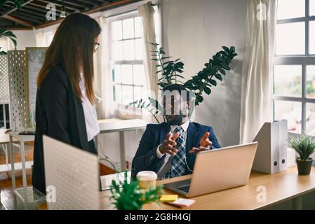 Multiracial team working inside modern office - Focus on african man face Stock Photo