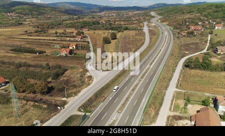 Road curves through rural landscape Stock Photo