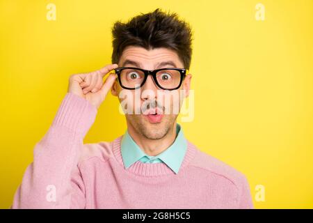 Photo of young handsome serious shocked amazed surprised man in funky glasses isolated on yellow color background Stock Photo