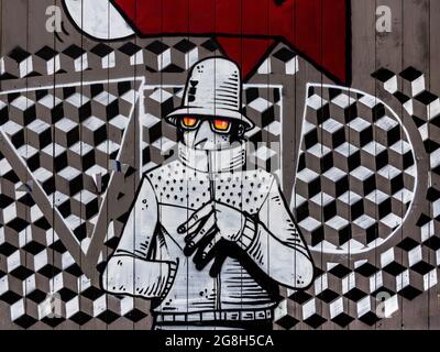 Monochrome mural of man and patterned background on wall - Paris, France. Stock Photo