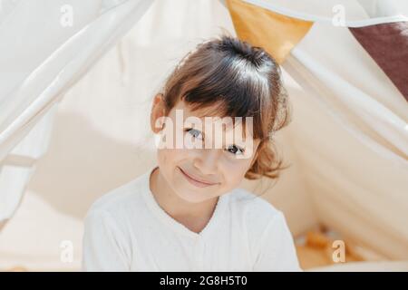 cute girl playing in teepee with fabric tilda bunny at home Stock Photo ...