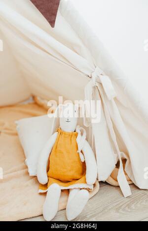 Tilda bunny handmade in white clothes to decorate the house on a white ...