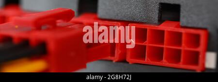 Power wires and plastic parts for a computer close-up. Combining electrical cables into an industrial installation Stock Photo