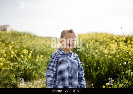 Young Boy Laughing in Wildflower Field in San Diego Stock Photo