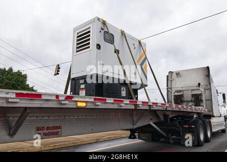 Columbia County, Ga USA - 05 12 21: Semi truck with heavy industrial power technology cargo Stock Photo