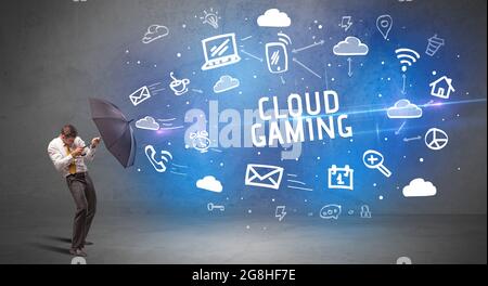 Businessman defending with umbrella, modern technology concept Stock Photo