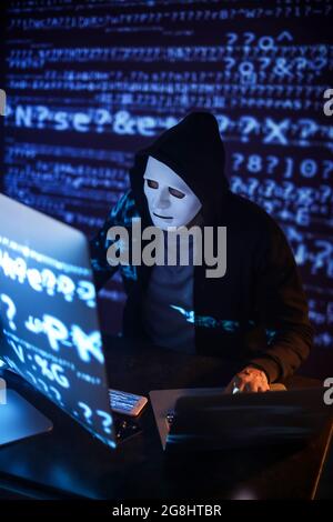 Hacker using computers in dark room Stock Photo - Alamy
