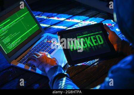 Hacker using computers in dark room Stock Photo - Alamy