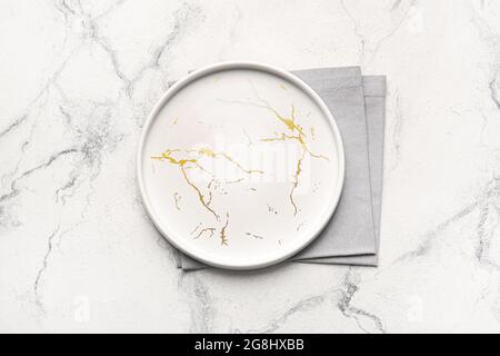 Fabric napkins and plate on light background Stock Photo