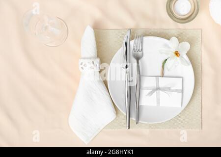 Beautiful table setting with narcissus flower Stock Photo
