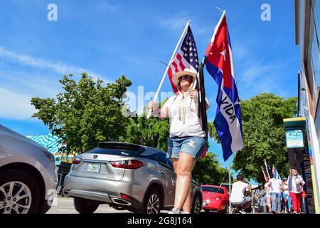 Miami, United States. 18th July, 2021. A protester walks with the flags ...