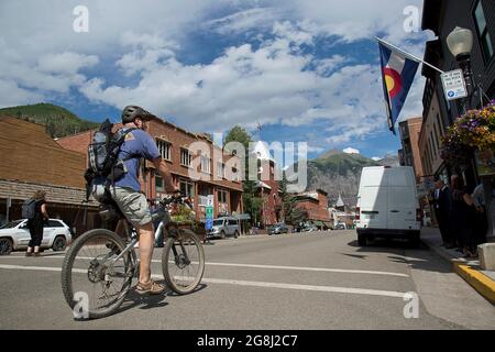 Telluride, COLORADO, USA. 17th July, 2021. July 19, 2021. A bike rider rolls down Main St. in Telluride, Colo, USA. in Telluride, Colorado. (Credit Image: © Ralph Lauer/ZUMA Press Wire) Stock Photo