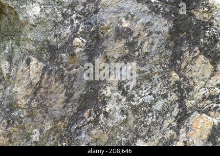 Variegated, multicolored texture of natural rock stone. Background. Stock Photo