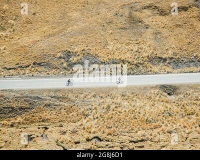 Mountain bikers riding the famous downhill trail Road of death in Bolivia. Stock Photo