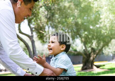 Father and son enjoying in the park, concept for father's day. Stock Photo