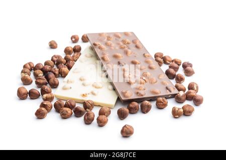 White and dark chocolate bars with hazelnuts isolated on white background. Stock Photo