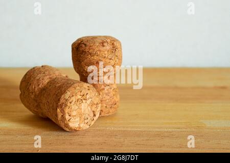 Two champagne corks on a wooden table. Close-up. Macro.  Stock Photo