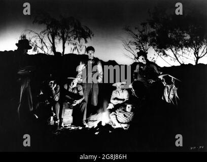 ROBERT MITCHUM with Hobos in THE NIGHT OF THE HUNTER 1955 director CHARLES LAUGHTON novel Davis Grubb screenplay James Agate cinematographer Stanley Cortez music Walter Schumann art direction Hilyard M. Brown Paul Gregory Productions / United Artists Stock Photo