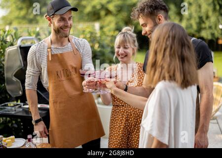 Friends celebrating with alcohol drinks outdoors Stock Photo