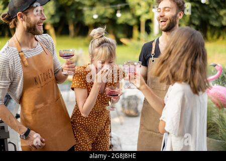 Friends celebrating with alcohol drinks outdoors Stock Photo